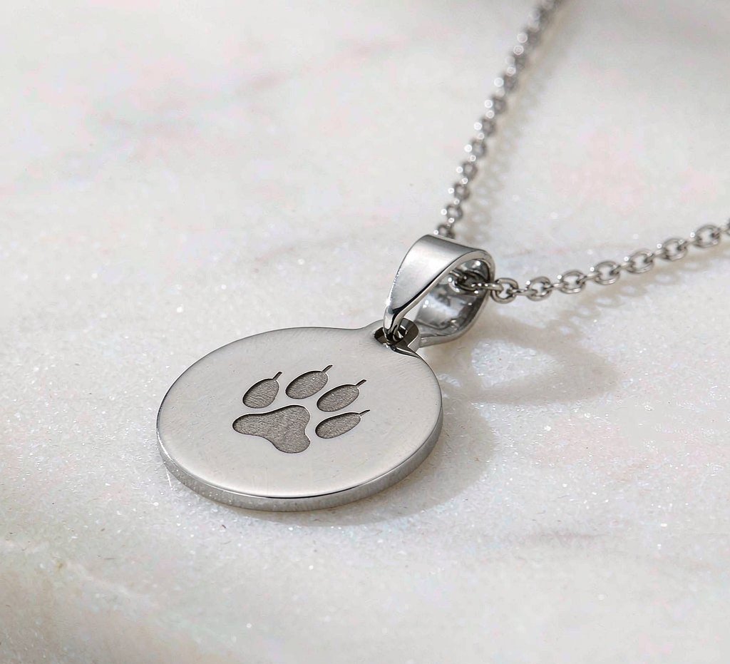 Paw print keepsake pendant in solid metal